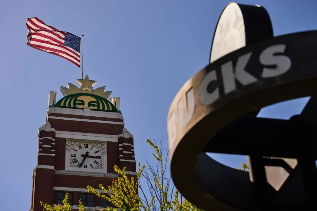 Starbucks headquarters in Seattle with an American flag as the company announces corporate layoffs in 2026