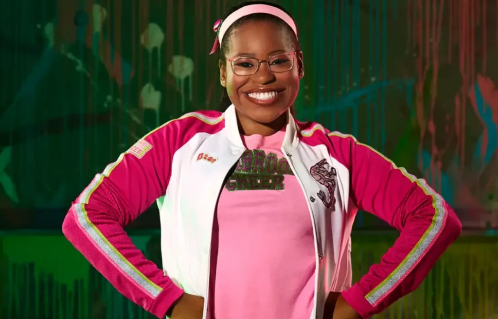 Carla Jeffery as Bree in Disney Channel’s Zombies franchise, wearing a pink Seabrook cheer outfit.