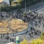 Masked demonstrators blocking a road during the Port of Dover protest in Kent