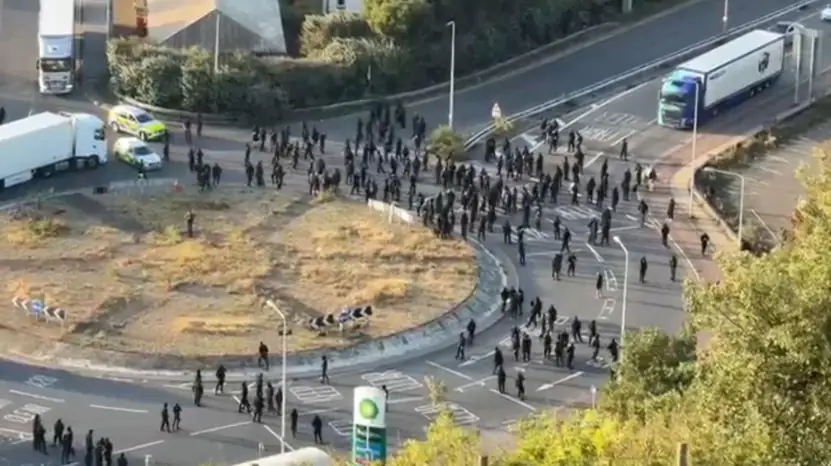 Masked demonstrators blocking a road during the Port of Dover protest in Kent