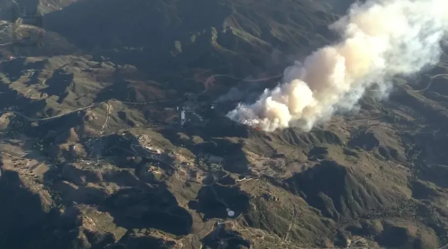 Bryson Fire burning through dry hills near Encinal Canyon in Malibu, California, during dangerous Santa Ana winds.