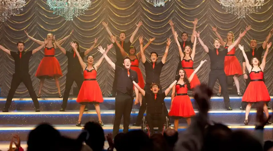 High school musical auditorium stage representing the Glee reboot confirmed for Disney+ and Hulu in October 2026.