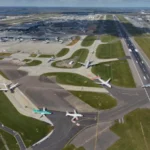 British Airways aircraft on a rain-soaked runway during severe UK weather as Storm Boelo disrupts Heathrow and Gatwick flights.